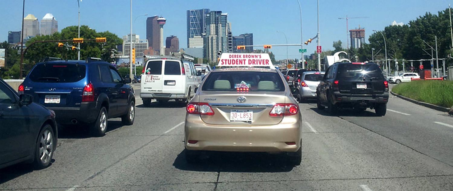 A student learning to drive in a Derek Brown's Academy of Driving car in Calgary, AB.