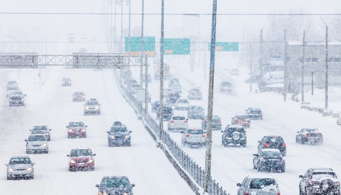 Cars driving on a snowy highway.