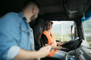 A truck driver being taught by an instructor